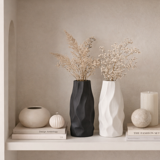 Pleated ceramic vase styled with delicate branches in a warm neutral interior with natural textures and minimalist decor.