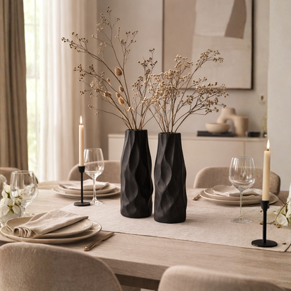 Pleated ceramic vase styled with delicate branches in a warm neutral interior with natural textures and minimalist decor.