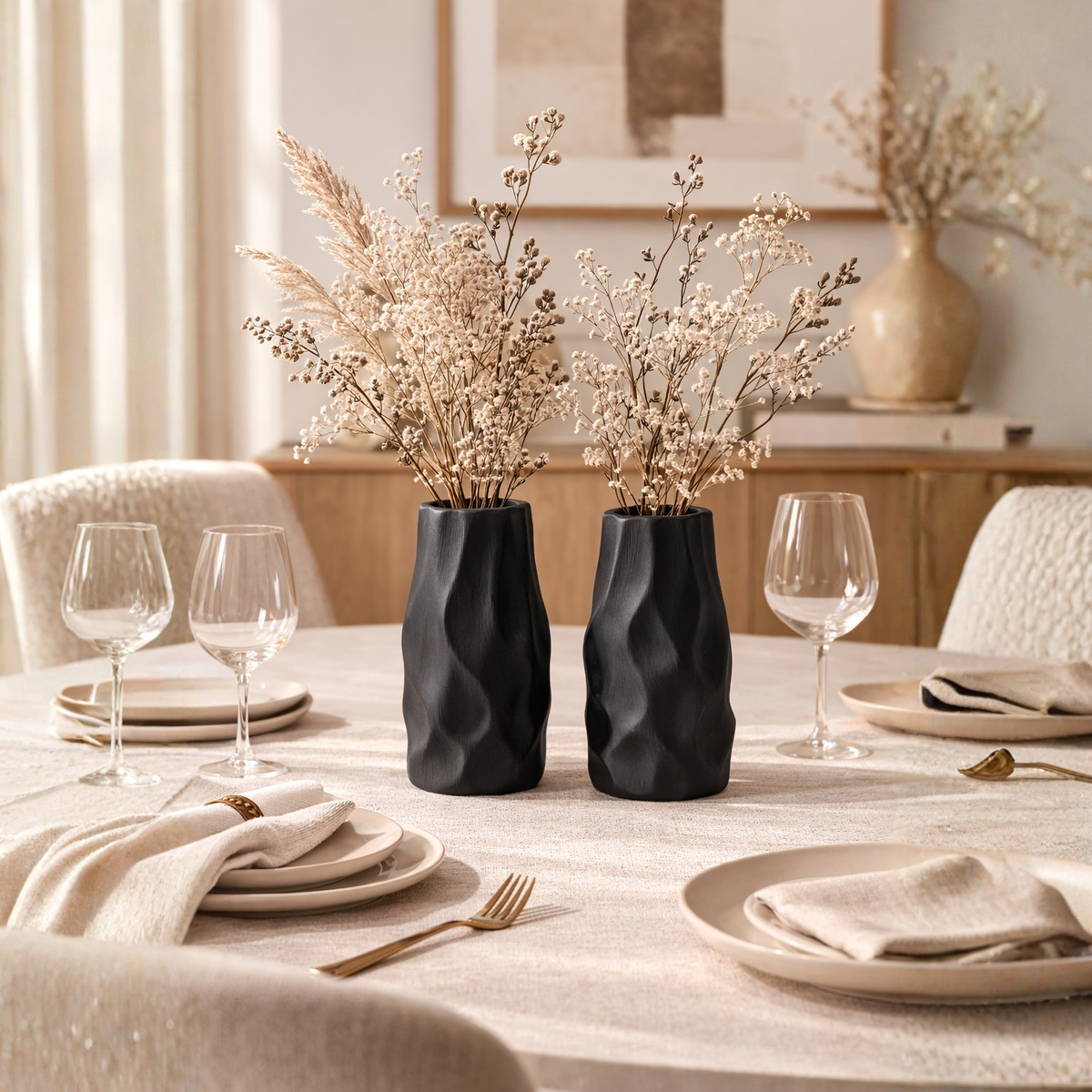 Pleated ceramic vase styled with delicate branches in a warm neutral interior with natural textures and minimalist decor.