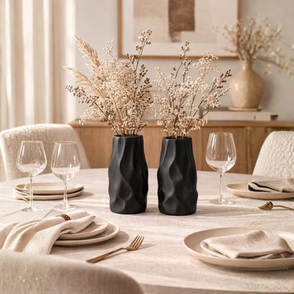 Pleated ceramic vase styled with delicate branches in a warm neutral interior with natural textures and minimalist decor.