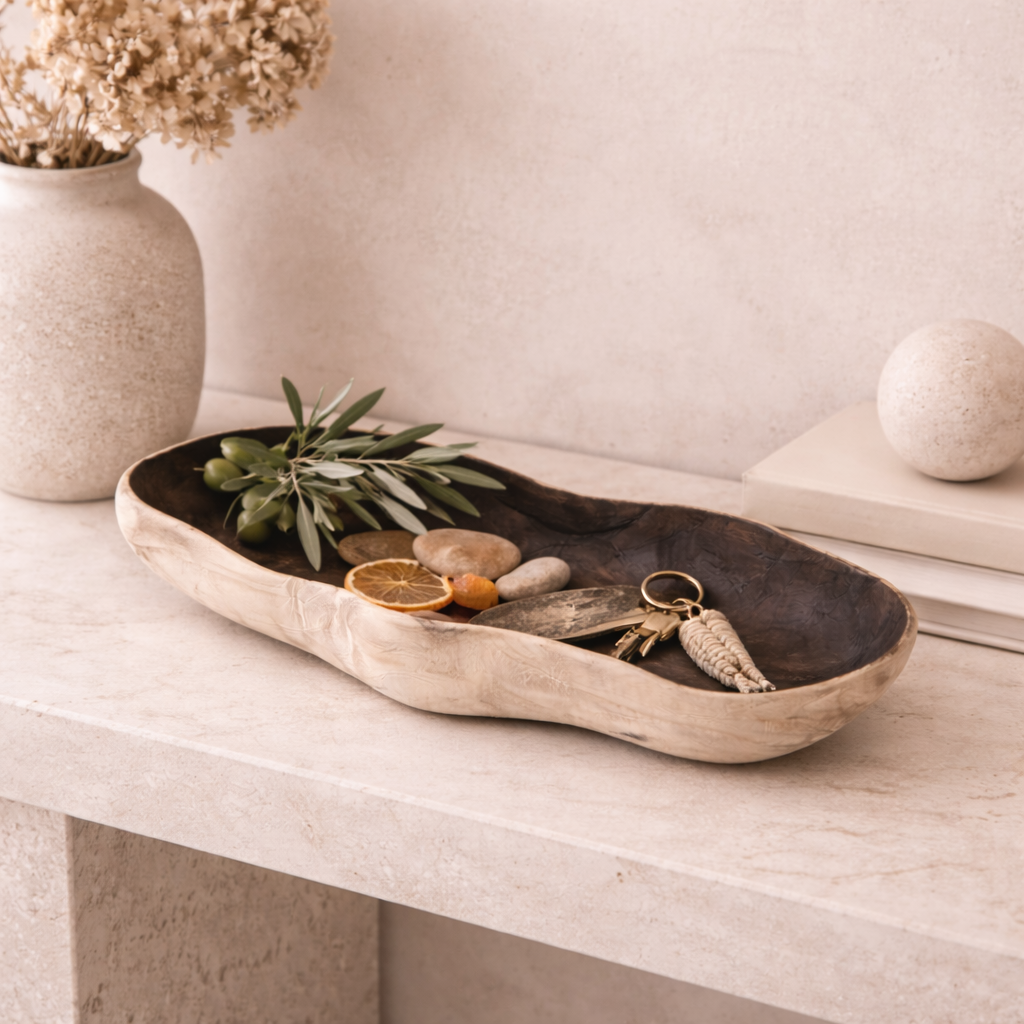 Sculptural natural wood tray styled in a warm neutral interior with organic textures and minimalist decor.