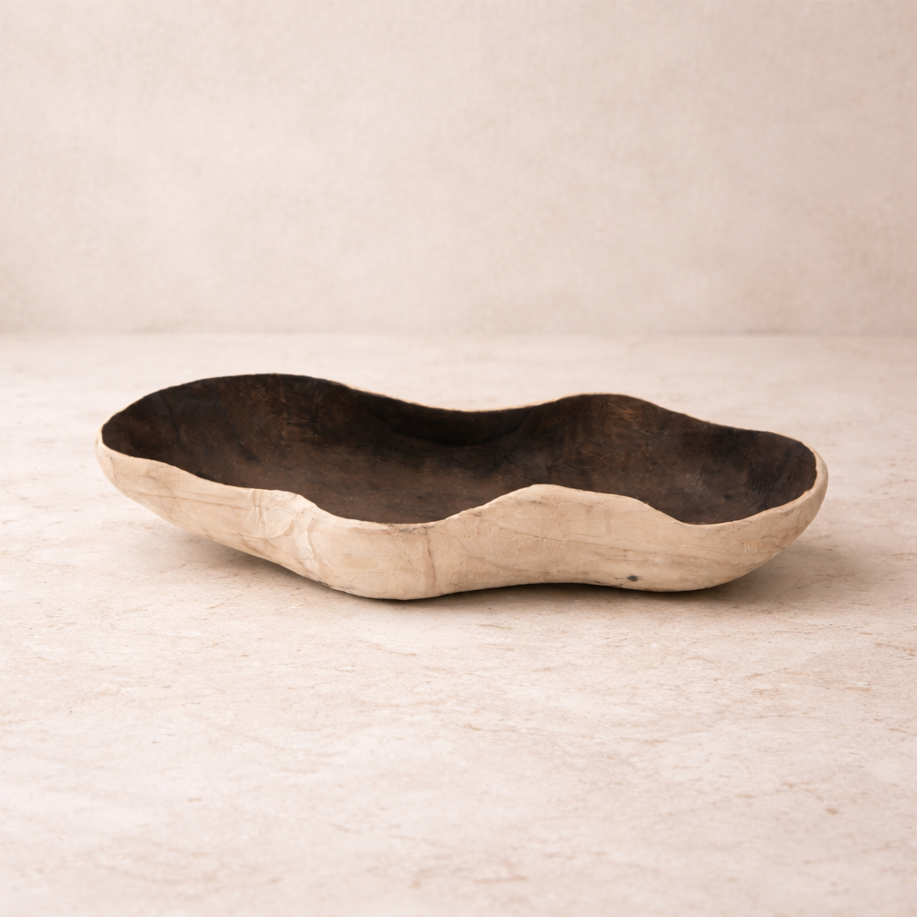 Sculptural natural wood tray styled in a warm neutral interior with organic textures and minimalist decor.